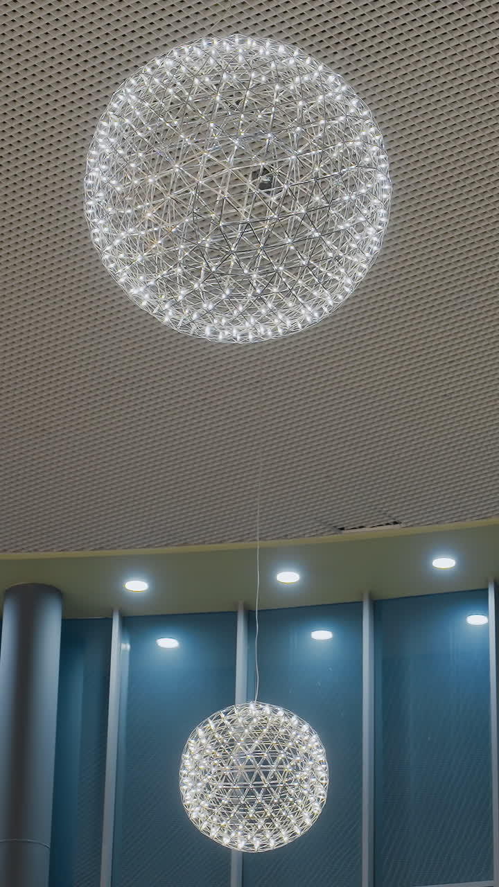 Beautiful decorative interior with elegant lighting and unique geometric chandelier design, soft glowing lights enhance modern, contemporary ambiance