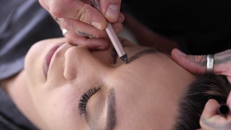 crop man drawing eyebrow to woman