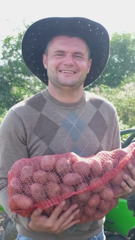 male farmer holding freshly harvested potatoes in beautiful countryside male farmer holding freshly harvested potatoes in beautiful countryside