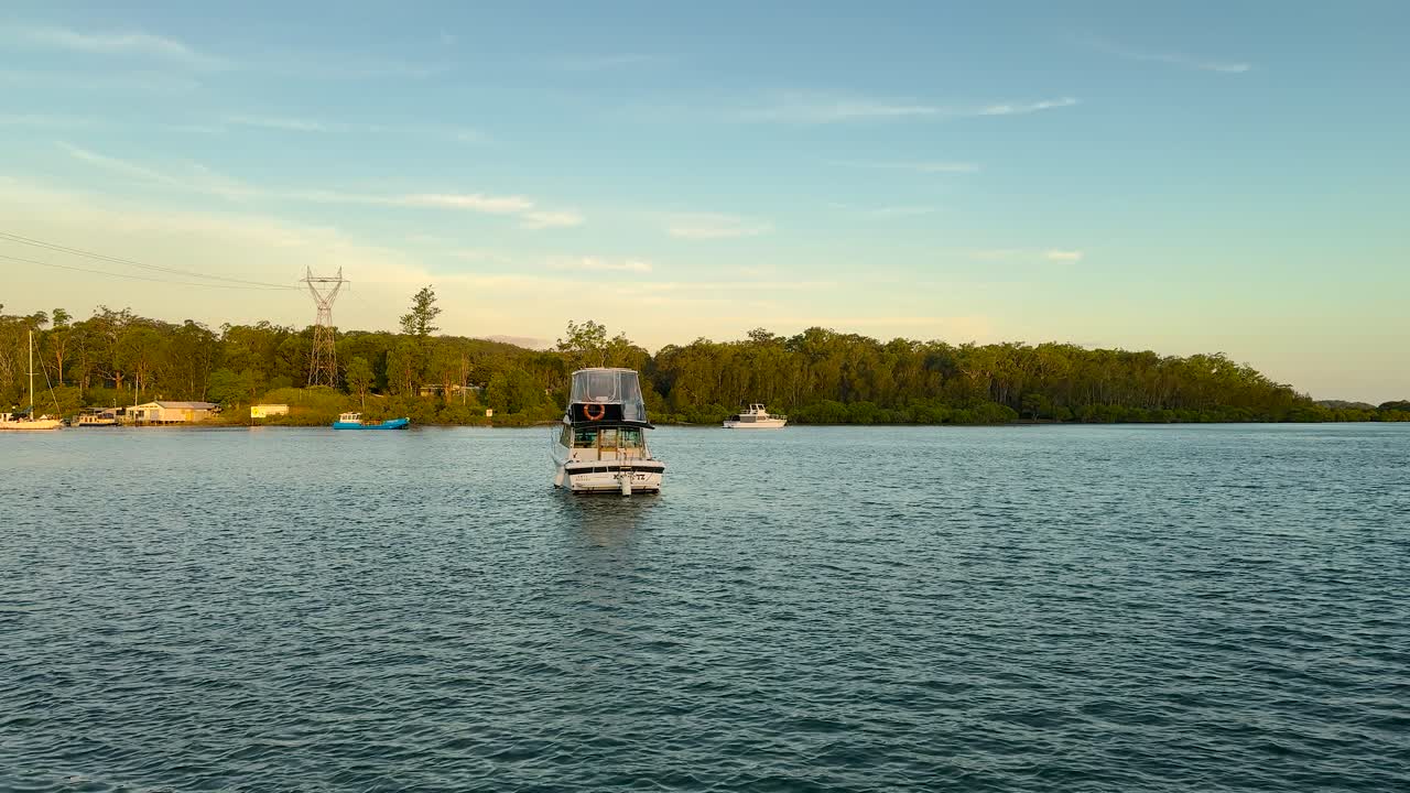 Sunrise view of a boat on the river in the regional town of Karuah, New South Wales, Australia.