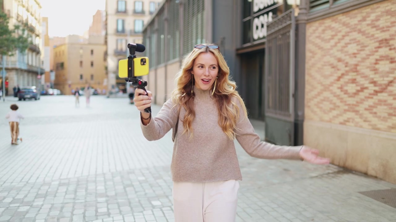 Vlogger donna felice che registra un video con lo smartphone all'aperto