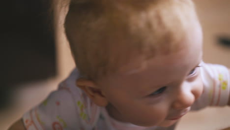 funny toddler with blue eyes looks with interest and laughs