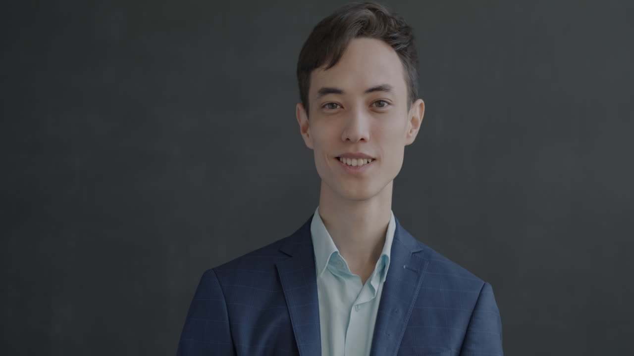 Man in a suit waving and smiling