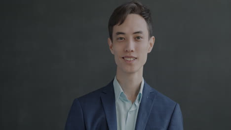 man in a suit waving and smiling