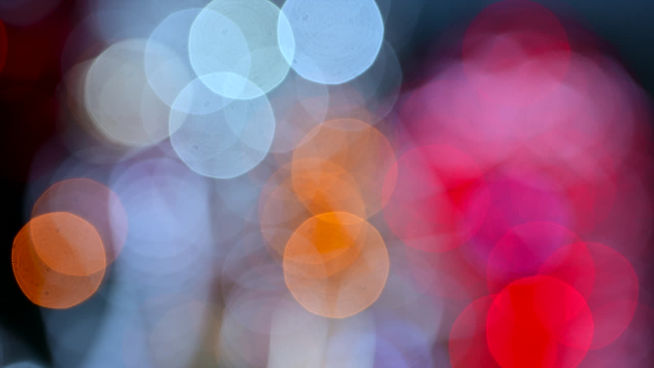 Abstract composition of colorful out of focus lights blending pink, blue, and white tones