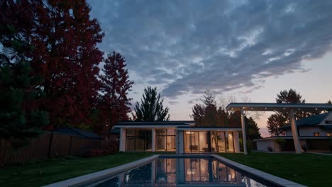 Modern house with pool at dusk, shot from a low angle. The video captures the serene ambiance