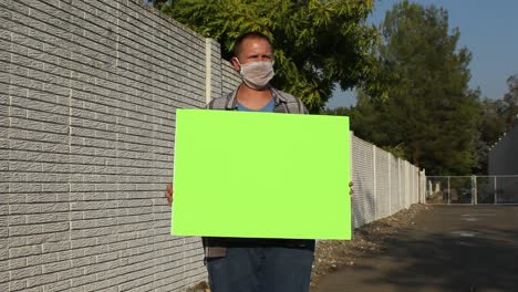 Anti-COVID-Protester-with-Mesh-Mask---Green-Screen-Sign-Horizontal