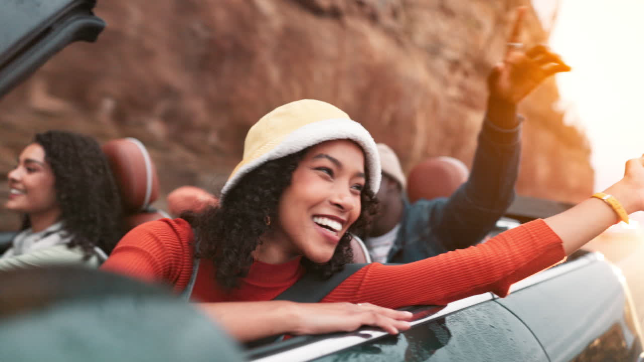 Friends enjoying a road trip in a convertible