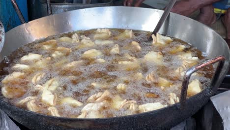 Samosas-being-fried-in-hot-oil-at-a-roadside-hotel-in-Kolkata,-India