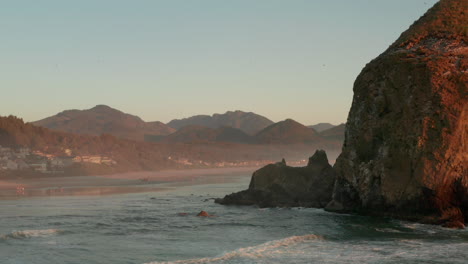 aerial shot past haystack rock towards cannon beach