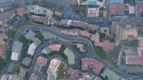 static aerial overhead top down footage of cars driving on different sections of a hill in naples, italy