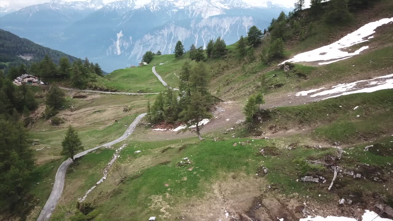 Side of a mountain in the swiss alps in valais in spring, blocks of snow melt in the sun