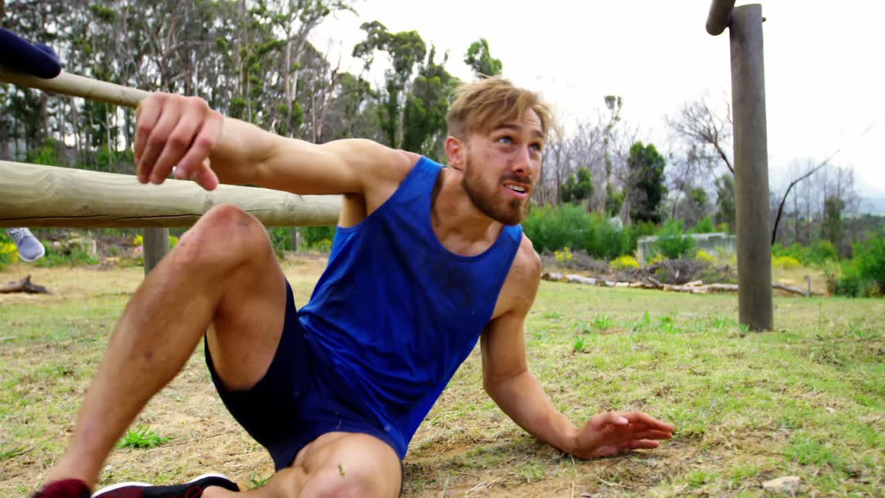 Fit people jumping over the hurdles during obstacle course 4k