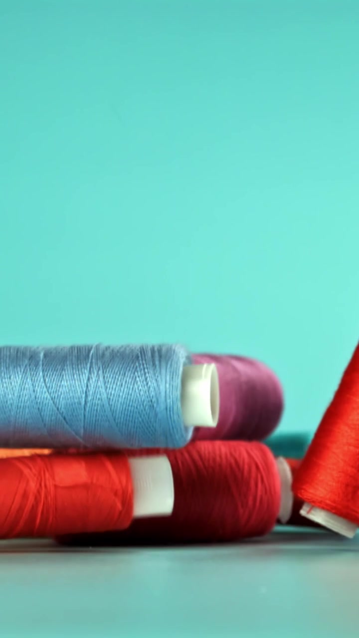 Colorful Spools of Thread Falling in Slow Motion
