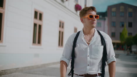 stylish man walking in a city street