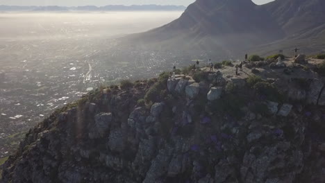 sun rays lens flare as drone flies over lion's head peak in cape town