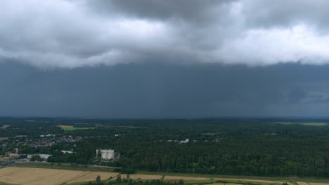 aerial view of a lightning storm and rain above forest on the countyside