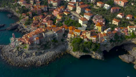 amazing aerial, reveal, shot of of beautiful, colorful, coastal village of tellaro and rolling hills