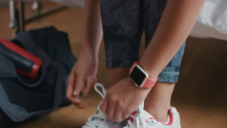 healthy woman at home getting ready for gym workout with smart watch