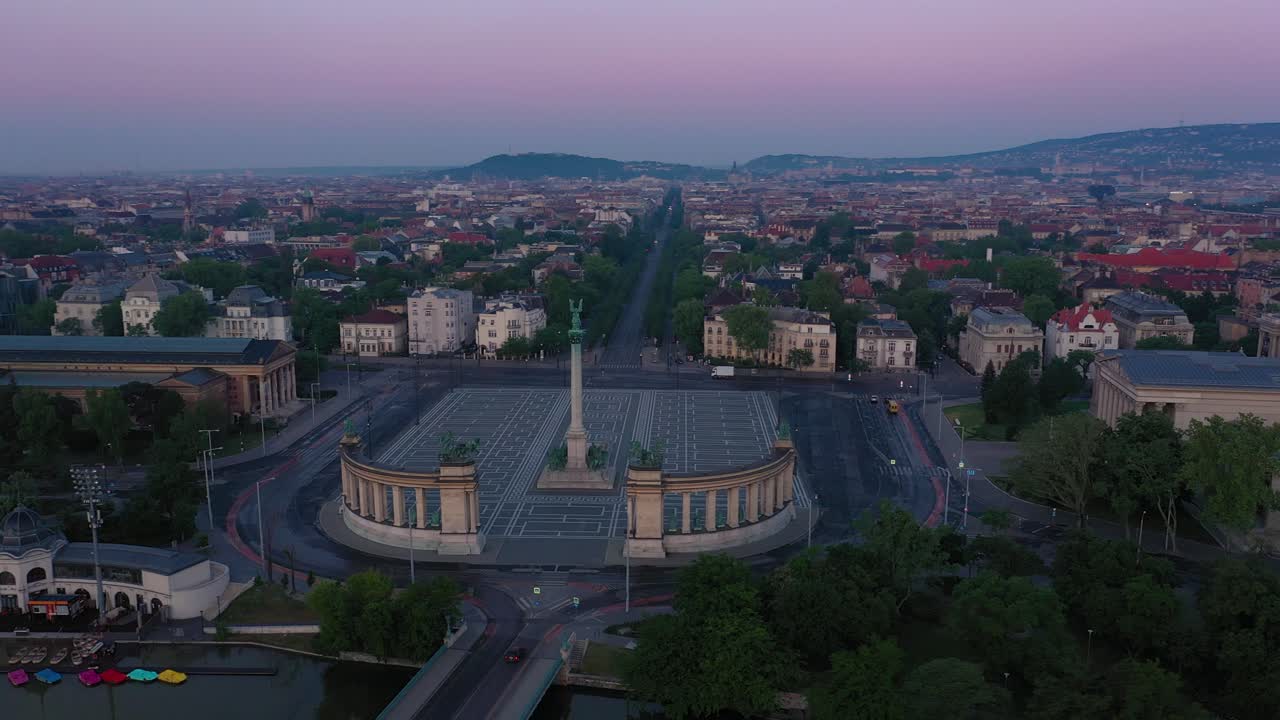 Drone footage of the empty Heroe's Square in Budapest, Hungary at the time of the Covid virus. Early morning at the sunrise in spring.Drone circles fast right.