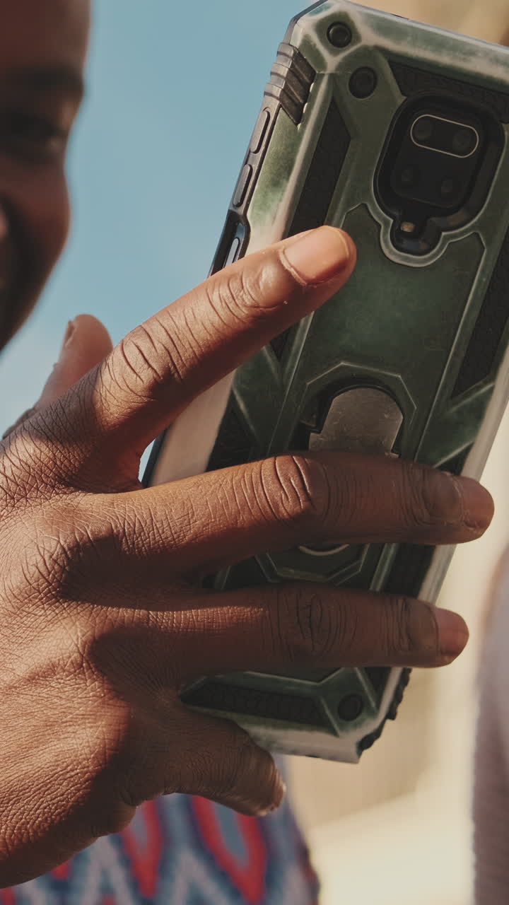 Person holding a cell phone in a protective case