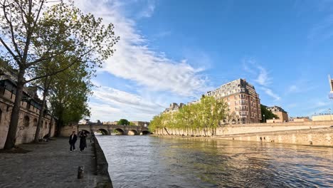 people walking by the seine river in paris