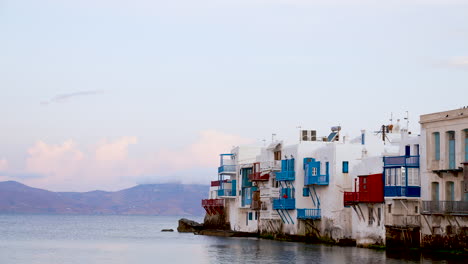 colorful porches jut out over the aegean sea in mykonos, greece