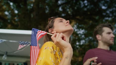 Close-up-of-group-of-young-friends-dancing-and-celebrating-4th-of-July-on-the-camping.