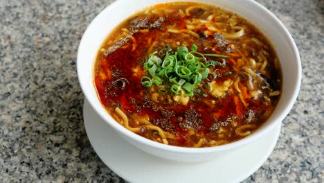 close up circle movement of sichuan hot and spicy soup in a bowl, chinese food or taiwan food in the restaurant