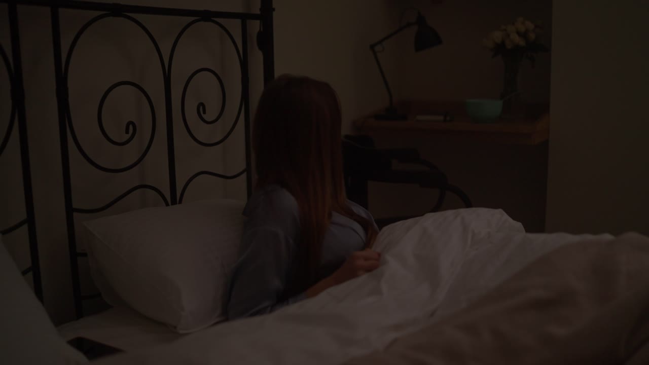 밤에 침대에서 깨어나는 여자