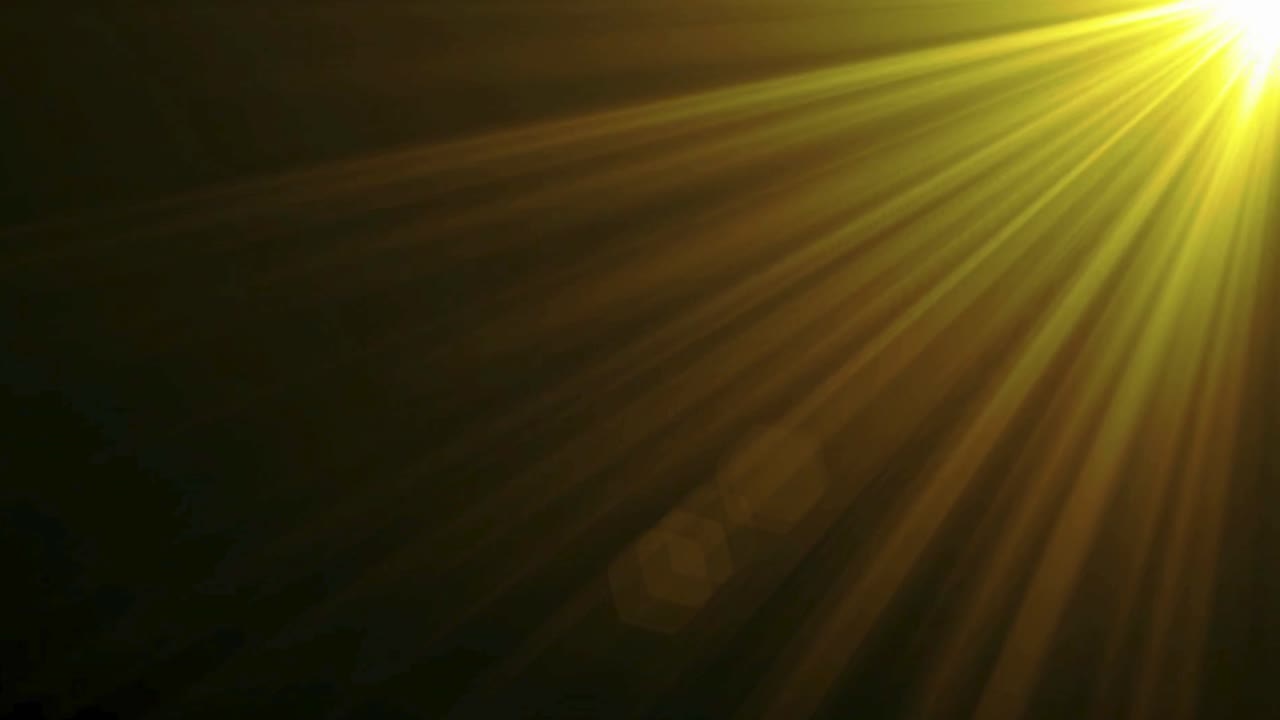 Raios de Luz Amarelos Brilhantes e Reflexo de Lente em Fundo Escuro