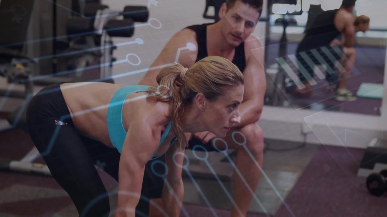 woman performing plank in gym weight area, with trainer observing and animated form lines
