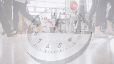 animation of ticking clock against low section of people walking at office