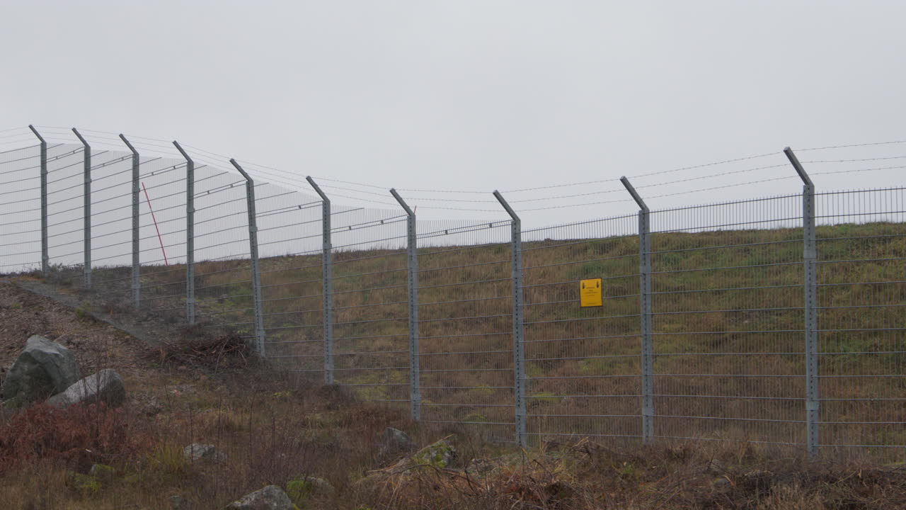 Slow pan of the security fence of Arlanda airport in Stockholm