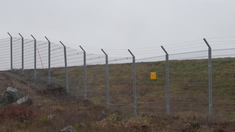 slow pan of the security fence of arlanda airport in stockholm