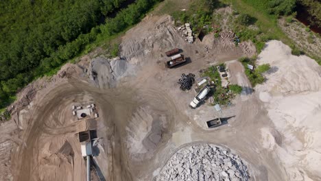 top-down aerial of ready mix concrete gravel pit showing active site layout, machinery, and bare terrain