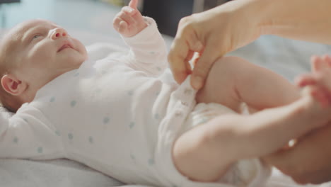 mother changing a baby's diaper