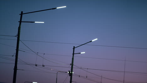 street lanterns illumining city road purple evening time. saving energy lamps.