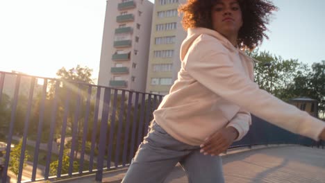 Low-angle-view-of-black-woman-dancing-on-the-bridge