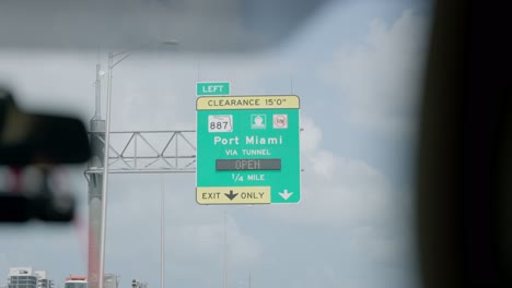 port miami sign in passing shot through a moving vehicle on summer day