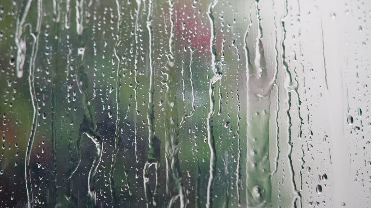Raindrops Falling and Running Down a Window Pane