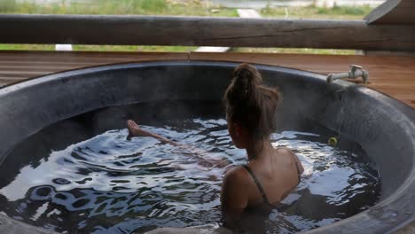 woman relaxing in a hot tub with a view