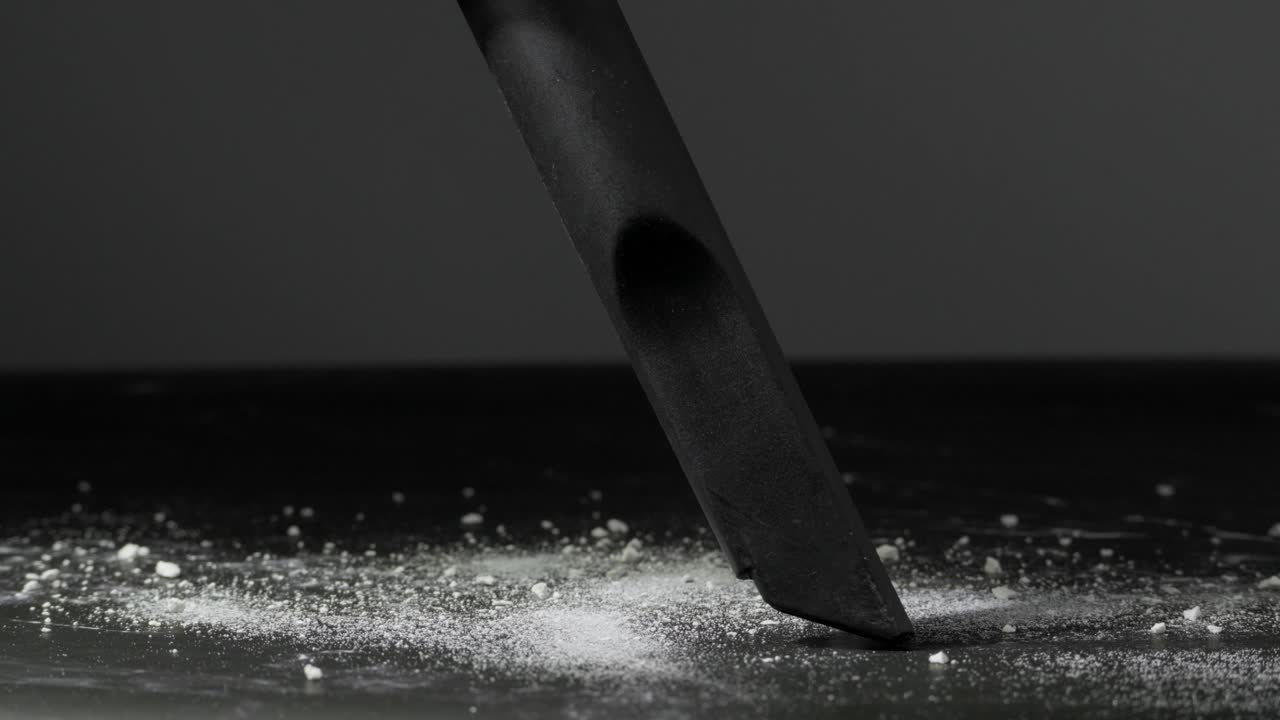 Close-up of a Vacuum Cleaner Nozzle Cleaning Dust on a Dark Floor