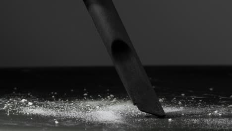 close-up of a vacuum cleaner nozzle cleaning dust on a dark floor