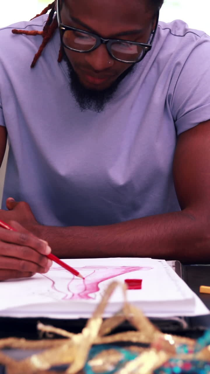 Focused fashion student drawing a dress