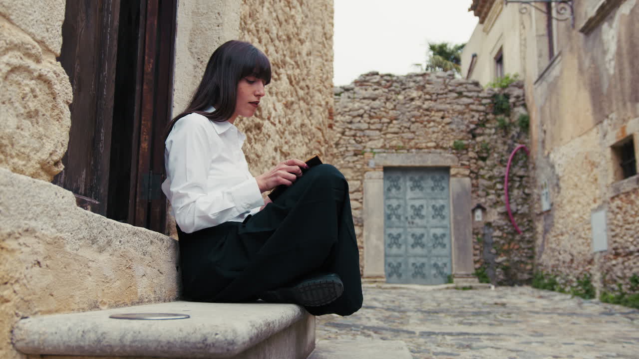 Woman Reading The Bible Book And Flipping Pages At The Entrance Of The Church