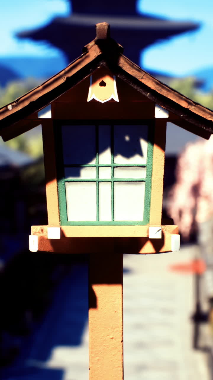 Traditional lantern stands in a serene street of an ancient town during daytime