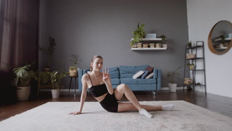 Wide-Shot-Of-A-Cute-And-Young-Female-Vlogger-Teaching-An-Online-Fitness-Class