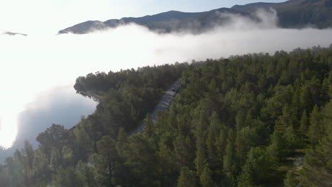 aerial-view-of-highway-in-Jotunheimen-National-Park-with-foggy-scenic-landscape,-Norway