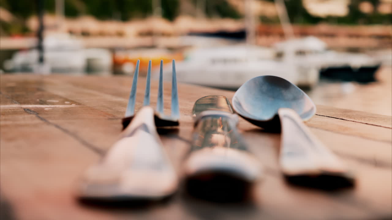 Close up view of a set table and the atmosphere at a restaurant near a port in the south of France